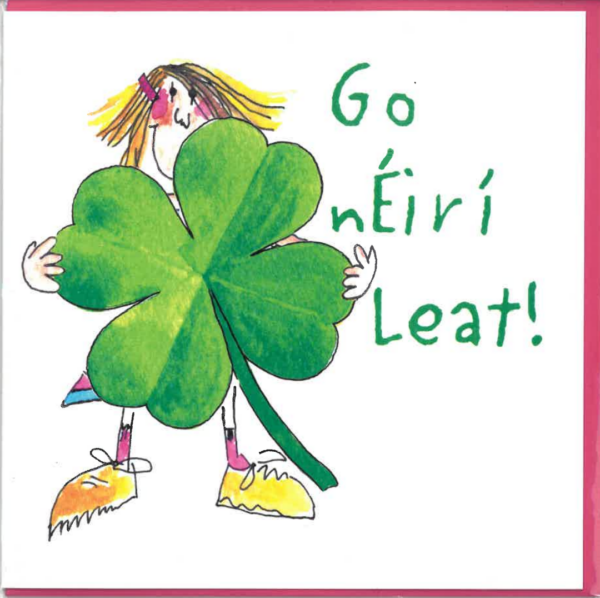 Go nÉirí Leat! Person standing behind giant four-leaf clover